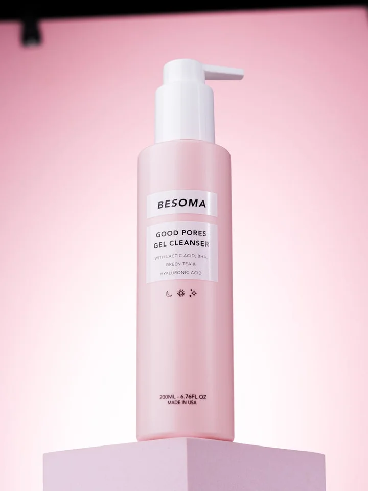 Pink Besoma Good Pores Gel Cleanser bottle with pump on a soft pink background.
