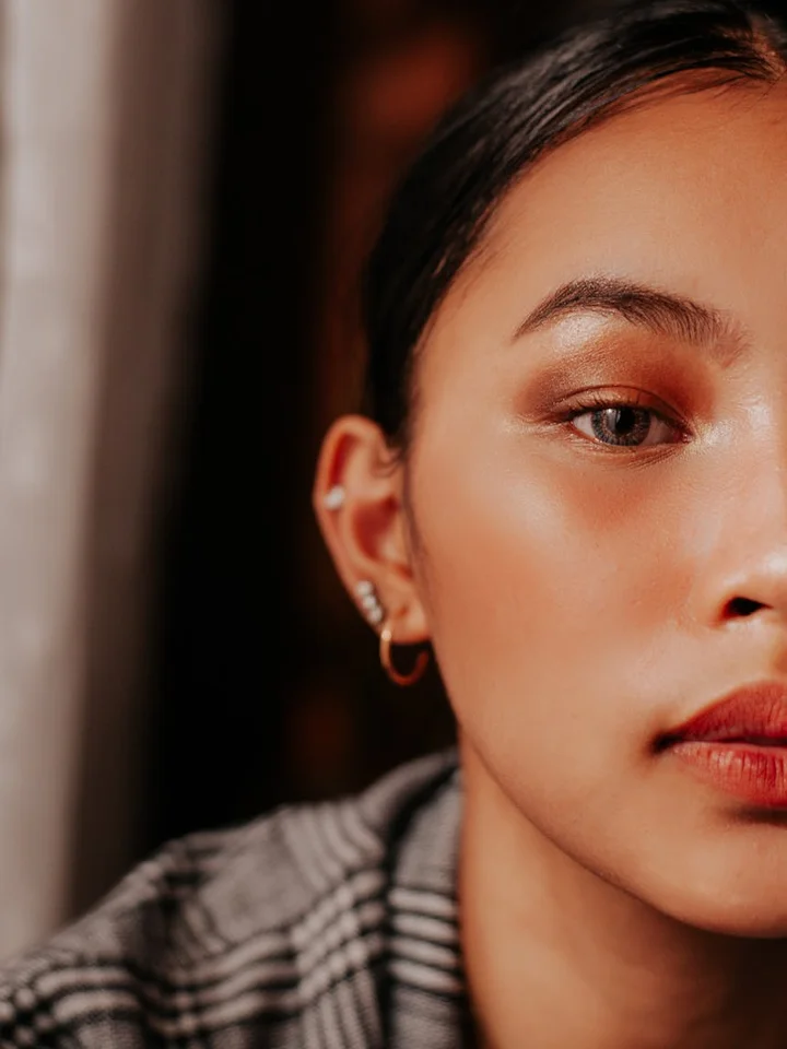 Close-up portrait of a person with dewy skin and natural makeup, illustrating a gentle, skin-friendly approach to makeup