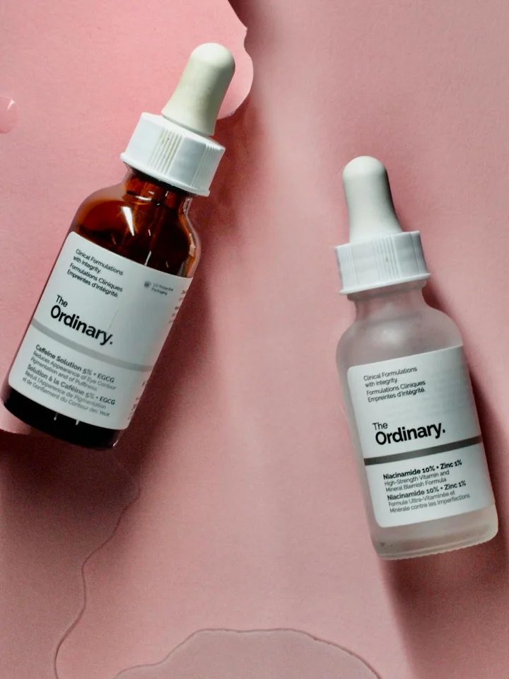 Two The Ordinary skincare serums with dropper bottles placed on a pink background, illustrating careful product selection for sensitive skin.