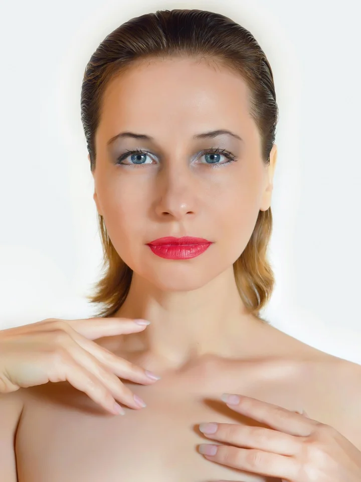 Close-up portrait of a woman with fair skin, light makeup, and a calm expression.