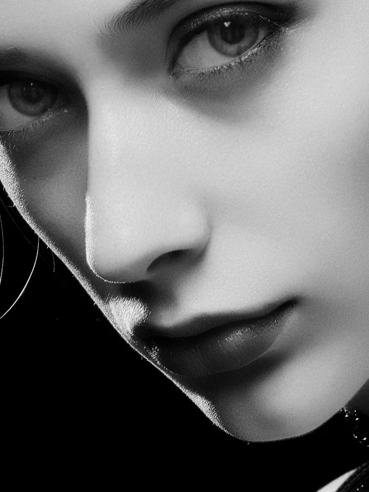 Close-up black-and-white portrait of a woman's face, focusing on her cheek and nose.