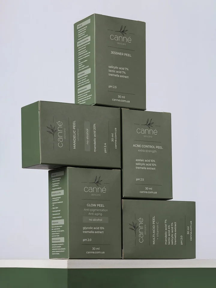 Stack of green skincare peel boxes arranged in a pyramid, with labels such as Acne Control Peel and Glow Peel.