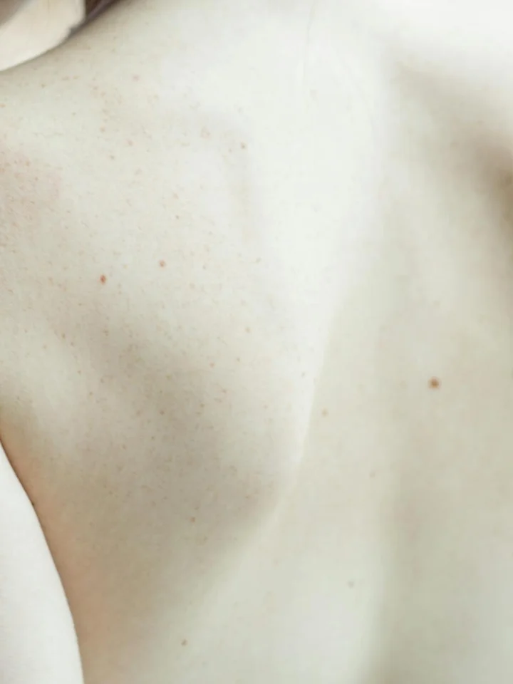 Close-up of smooth skin on a back with a few small pores, illustrating a healthy skin barrier
