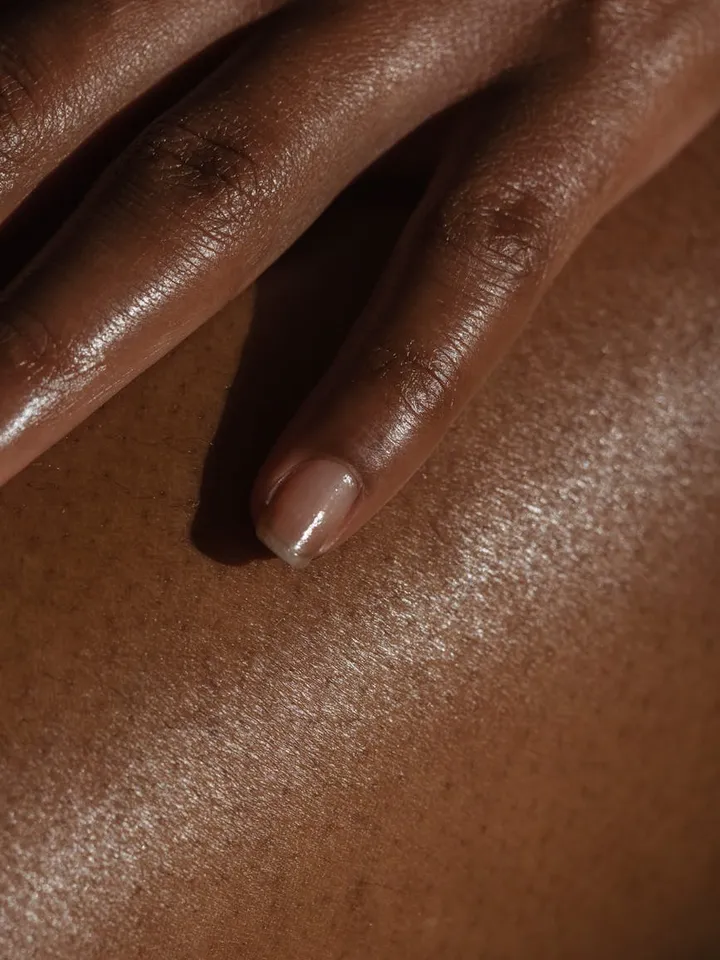 Close-up of skin on a finger with a shiny, glossy surface.