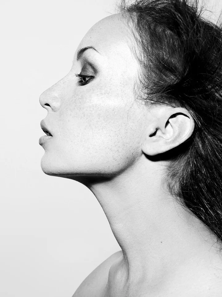 Black-and-white side profile of a woman's face and neck